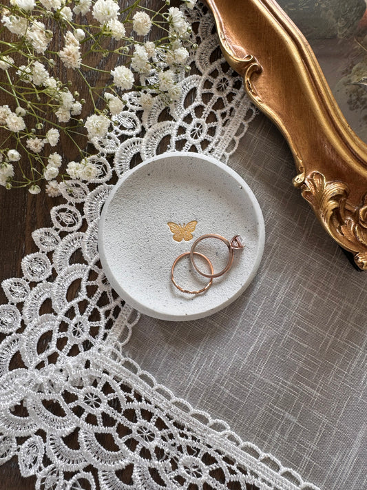 white clay speckled ring dish with gold simple butterfly in center, perfect for wedding couples